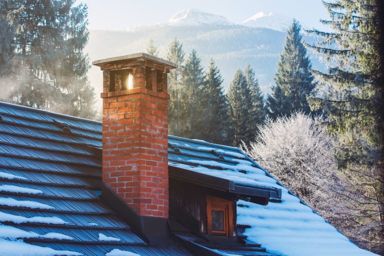 Mountain cottage chimney in winter